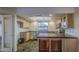 Well-lit kitchen featuring light wood cabinets and tile floors at 3906 W Aire Libre Ave, Phoenix, AZ 85053