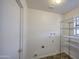 Laundry room offers tile flooring and shelving for storage at 3906 W Aire Libre Ave, Phoenix, AZ 85053