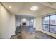 Open living room with fireplace, tile floors and large windows at 3906 W Aire Libre Ave, Phoenix, AZ 85053
