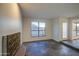 Living room featuring stylish tile flooring, an iron fireplace, and an abundance of natural light at 3906 W Aire Libre Ave, Phoenix, AZ 85053
