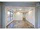 Open living room with tile floors and ample natural light at 3906 W Aire Libre Ave, Phoenix, AZ 85053