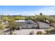 Sprawling home boasts a well-manicured yard with desert landscaping, a long driveway, and a detached garage at 4035 E Mcdonald Dr, Phoenix, AZ 85018