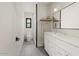 Well-lit bathroom with white vanity, sleek fixtures, and a modern shower design at 4035 E Mcdonald Dr, Phoenix, AZ 85018