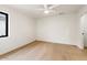 Bright, spacious bedroom with hardwood flooring and natural light from black-framed window at 4035 E Mcdonald Dr, Phoenix, AZ 85018