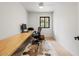 Bright bedroom with desk, chair, computer, and hardwood floors at 4035 E Mcdonald Dr, Phoenix, AZ 85018