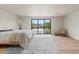 Bright bedroom featuring a large window with natural light and light wood floors at 4035 E Mcdonald Dr, Phoenix, AZ 85018