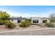 Attractive single-story home with minimalist desert landscaping, enhancing curb appeal and modern design elements at 4035 E Mcdonald Dr, Phoenix, AZ 85018