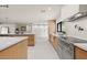 Modern kitchen featuring stainless steel appliances, stone counters, and natural wood cabinets at 4035 E Mcdonald Dr, Phoenix, AZ 85018