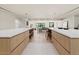 Spacious modern kitchen featuring dual islands with stone countertops and natural wood cabinets at 4035 E Mcdonald Dr, Phoenix, AZ 85018