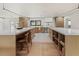 Spacious kitchen featuring double islands with seating, wood cabinetry, and ample counter space for cooking at 4035 E Mcdonald Dr, Phoenix, AZ 85018