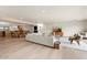 Open-concept living space with hardwood floors, comfortable seating, and seamless transition to the dining area at 4035 E Mcdonald Dr, Phoenix, AZ 85018
