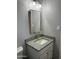 Bathroom features a framed mirror, vanity with granite countertop, and modern lighting at 4701 N 39Th Dr, Phoenix, AZ 85019