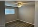 Cozy bedroom featuring a window, ceiling fan, and light neutral paint at 4701 N 39Th Dr, Phoenix, AZ 85019