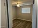 Cozy bedroom with wood-look flooring, a ceiling fan, and a window with bright light at 4701 N 39Th Dr, Phoenix, AZ 85019