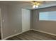 Bright bedroom features a ceiling fan, light gray walls, and wood-look flooring at 4701 N 39Th Dr, Phoenix, AZ 85019