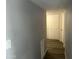 Hallway with wood-look floors leading to storage cupboards and an external door at 4701 N 39Th Dr, Phoenix, AZ 85019