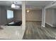 Bright open-concept living room with wood floors and a glimpse of kitchen and dining at 4701 N 39Th Dr, Phoenix, AZ 85019