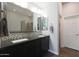 Bathroom featuring double sinks, a large mirror, and a tiled shower with a glass door at 4777 S Fulton Ranch Blvd # 1050, Chandler, AZ 85248