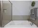Bathroom featuring a soaking tub with a shower and neutral tile surround at 4777 S Fulton Ranch Blvd # 1050, Chandler, AZ 85248