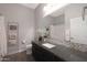 Well-lit bathroom with a granite countertop, dark wood cabinetry, and stylish mosaic backsplash at 4777 S Fulton Ranch Blvd # 1050, Chandler, AZ 85248