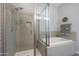 Bathroom featuring a soaking tub with a shower and neutral tile surround at 4777 S Fulton Ranch Blvd # 1050, Chandler, AZ 85248