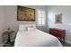 Well-lit bedroom with shutters, a decorative mirror, and a red dresser at 4777 S Fulton Ranch Blvd # 1050, Chandler, AZ 85248