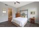 Cozy bedroom with a ceiling fan, wood-look tile flooring, and an en-suite bathroom at 4777 S Fulton Ranch Blvd # 1050, Chandler, AZ 85248