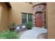 Cozy front entry with a stone accent wall, a bench, and lush plants at 4777 S Fulton Ranch Blvd # 1050, Chandler, AZ 85248