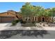 Charming home exterior with a stone facade, mature landscaping, and a two-car garage at 4777 S Fulton Ranch Blvd # 1050, Chandler, AZ 85248