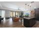 Open-concept living room and kitchen featuring granite island and sliding glass doors at 4777 S Fulton Ranch Blvd # 1050, Chandler, AZ 85248