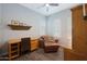 Bright home office featuring a wooden desk, comfortable lounge chair, and shuttered windows at 4777 S Fulton Ranch Blvd # 1050, Chandler, AZ 85248