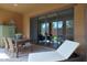 Inviting covered patio with dining set, lounge chair, and seamless indoor-outdoor transition through sliding glass doors at 4777 S Fulton Ranch Blvd # 1050, Chandler, AZ 85248