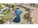 Aerial view of community pond amidst lush landscaping and upscale homes, creating a serene and picturesque setting at 4777 S Fulton Ranch Blvd # 1050, Chandler, AZ 85248