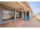 Covered back patio with brick pavers, ceiling fan, and sliding glass doors to the interior at 514 E Barrus Pl, Casa Grande, AZ 85122