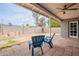 Cozy back patio with two blue Adirondack chairs, brick pavers, string lights, and ceiling fan at 514 E Barrus Pl, Casa Grande, AZ 85122