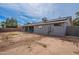 View of the home's backyard and back patio with solar panels on the roof at 514 E Barrus Pl, Casa Grande, AZ 85122