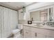 This bathroom features a neutral color scheme, a single sink vanity, and a shower with a decorative curtain at 514 E Barrus Pl, Casa Grande, AZ 85122