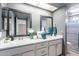 Bathroom features double sinks, granite countertops, and decorative mirrors at 514 E Barrus Pl, Casa Grande, AZ 85122