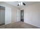 This spacious bedroom includes carpet flooring, neutral walls, a closet with sliding doors, and a ceiling fan at 514 E Barrus Pl, Casa Grande, AZ 85122