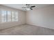 This cozy bedroom features neutral walls, carpet flooring, and a window with wood blinds that let in natural light at 514 E Barrus Pl, Casa Grande, AZ 85122