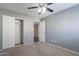 This comfortable bedroom includes carpet flooring, neutral walls, a closet with sliding doors, and a ceiling fan at 514 E Barrus Pl, Casa Grande, AZ 85122