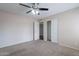 This spacious bedroom includes carpet flooring, neutral walls, a closet with sliding doors, and a ceiling fan at 514 E Barrus Pl, Casa Grande, AZ 85122