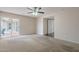 Bedroom boasts carpet, ceiling fan, and sliding door to patio and closet space at 514 E Barrus Pl, Casa Grande, AZ 85122