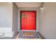 Close-up of the red double front doors with a welcome mat at 514 E Barrus Pl, Casa Grande, AZ 85122
