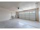 This spacious two car garage features concrete flooring and white painted walls at 514 E Barrus Pl, Casa Grande, AZ 85122