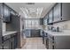 Spacious kitchen with black cabinets, stainless appliances, and ample counter space at 514 E Barrus Pl, Casa Grande, AZ 85122