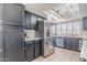 Kitchen with black cabinets, stainless steel fridge, and tiled floors at 514 E Barrus Pl, Casa Grande, AZ 85122
