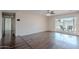 Open living room boasts dark wood floors, fan and sliding door to patio at 514 E Barrus Pl, Casa Grande, AZ 85122