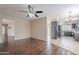 Open-concept living room featuring hardwood floors and views into the kitchen at 514 E Barrus Pl, Casa Grande, AZ 85122