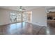 Spacious living room with hardwood floors, backyard access, and a view of the brick fireplace at 514 E Barrus Pl, Casa Grande, AZ 85122